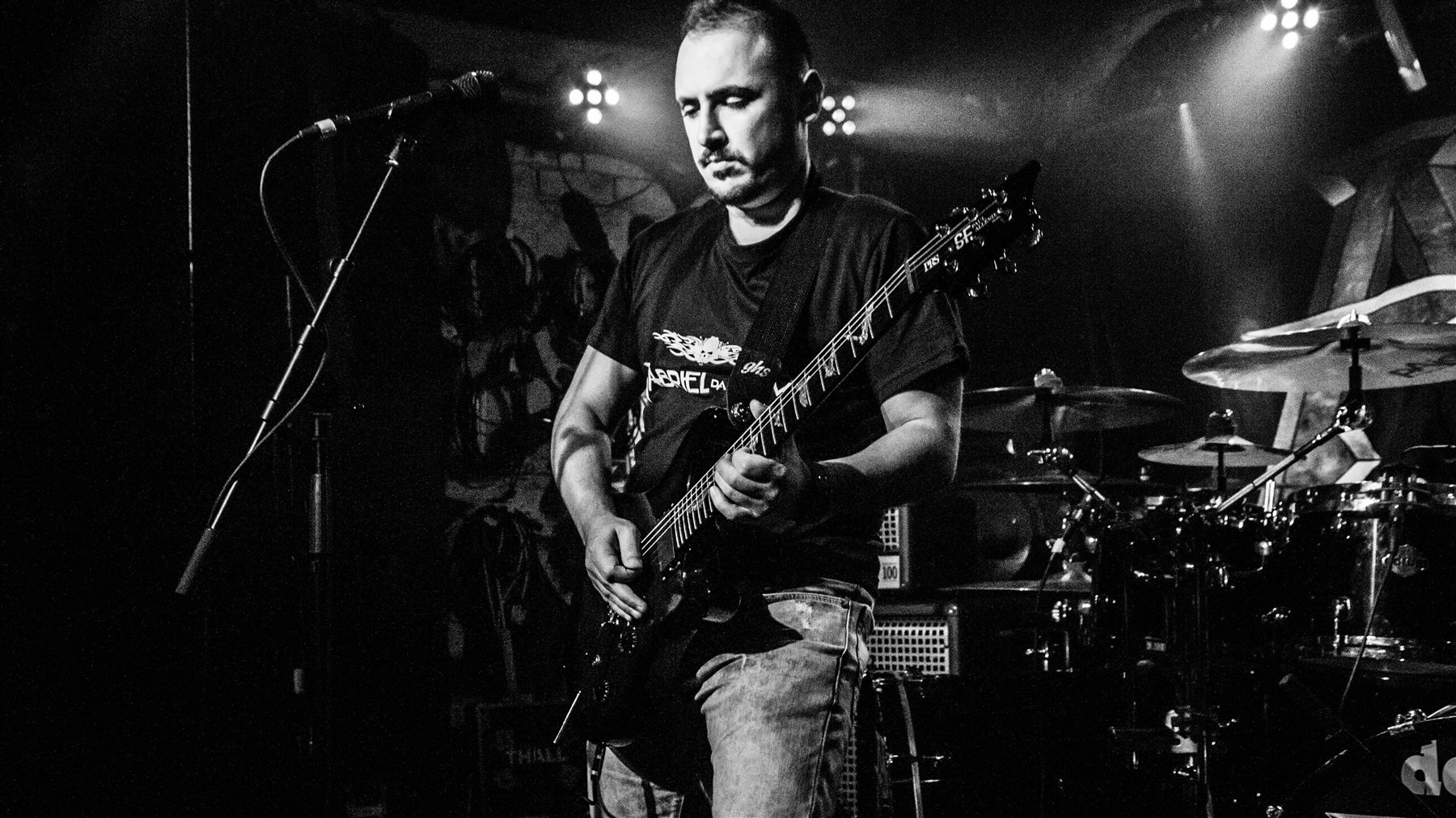 Gabriel playing guitar on stage